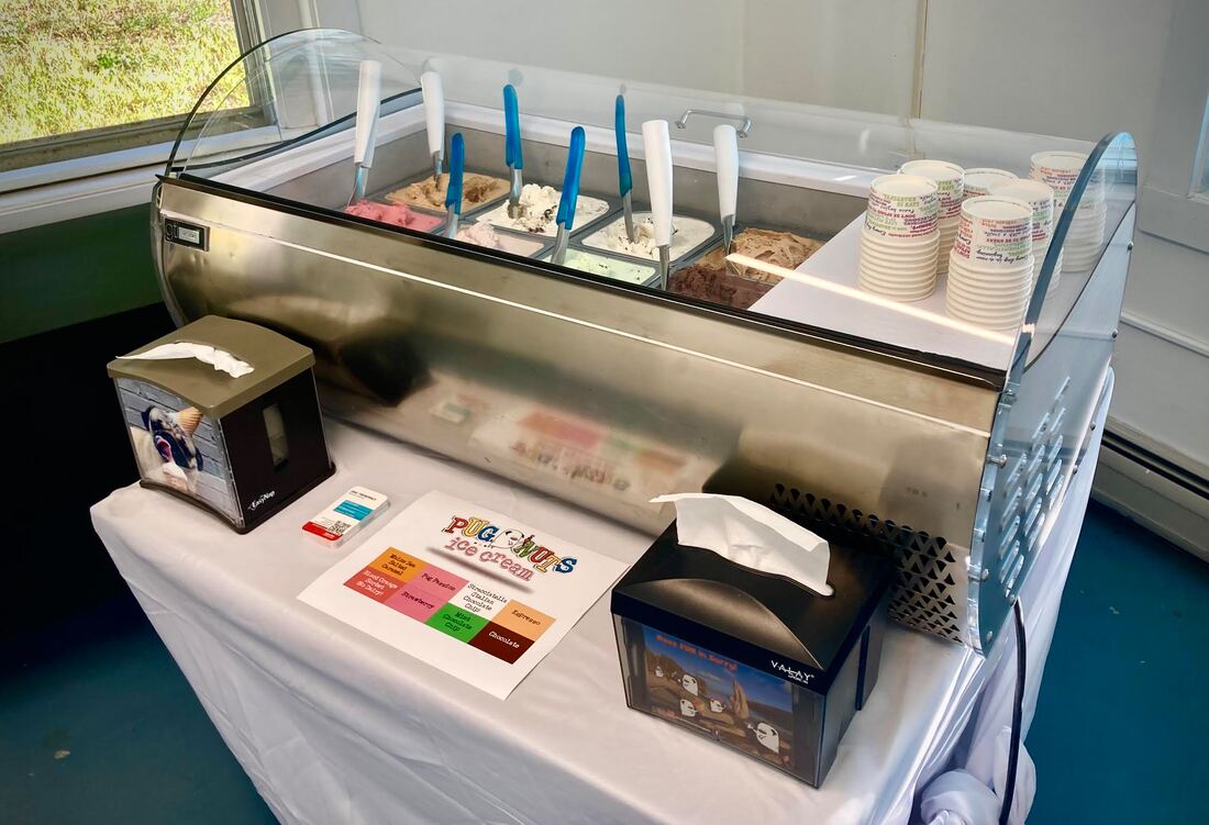 The traveling gelato display case serving guests at an outdoor event.