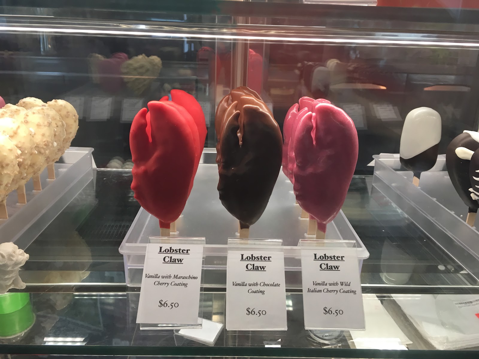 Hand-dipped Lobster Claw novelties on sticks: vanilla ice cream in red maraschino cherry, chocolate and pink wild-cherry shells.